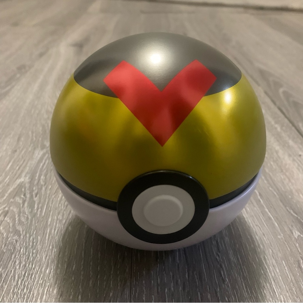 Gold and Black Level Poké Ball Toy Tin